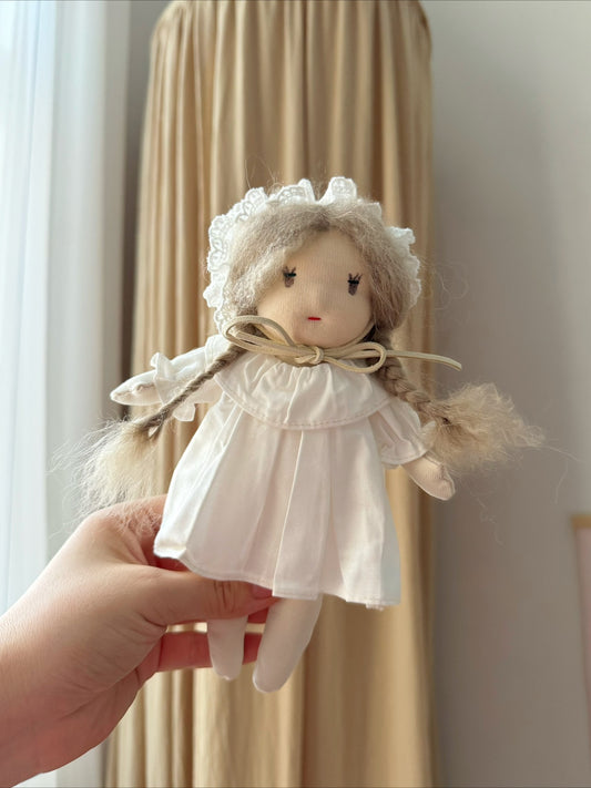 Mini doll in white skirt